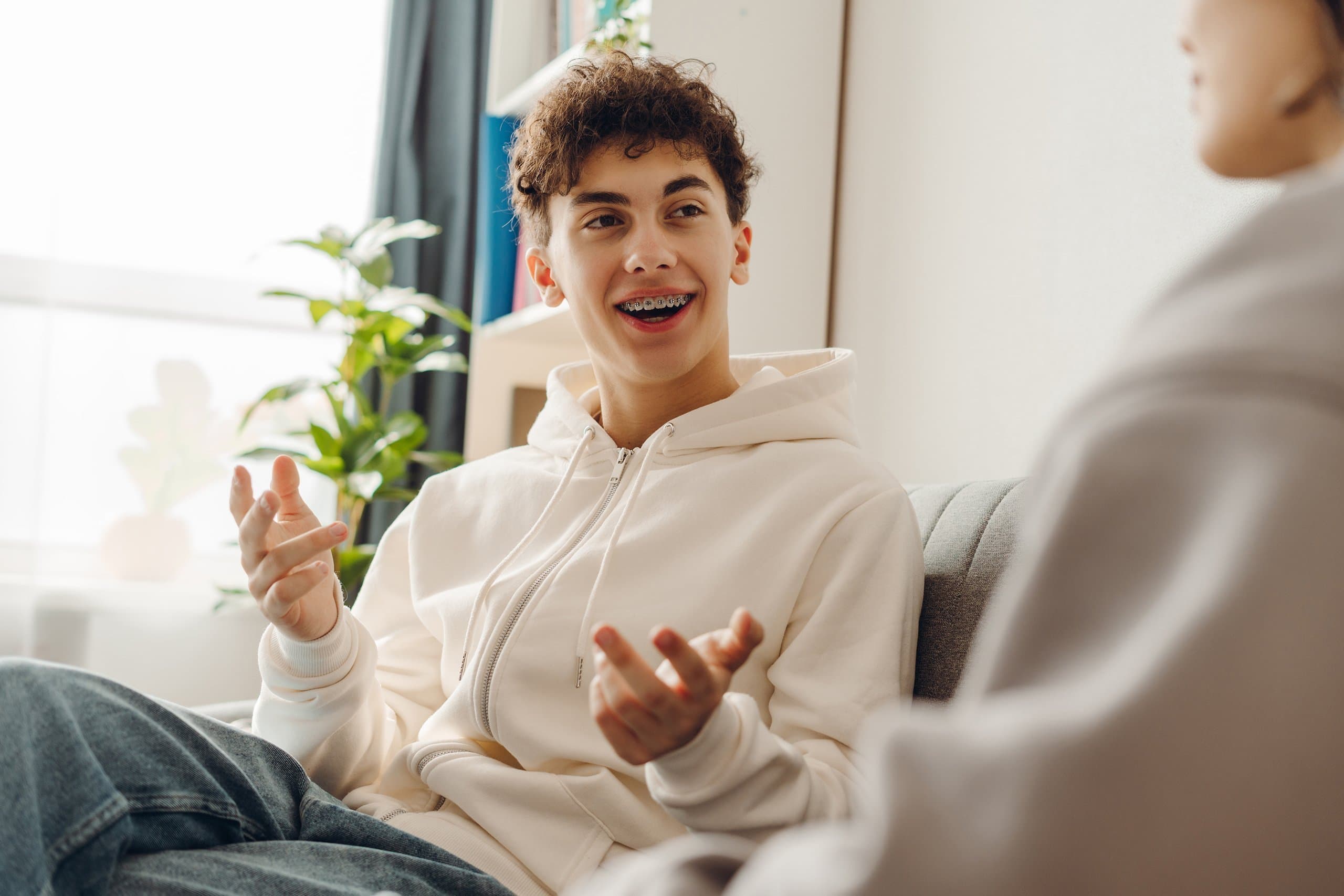 teenager happily talking on couch